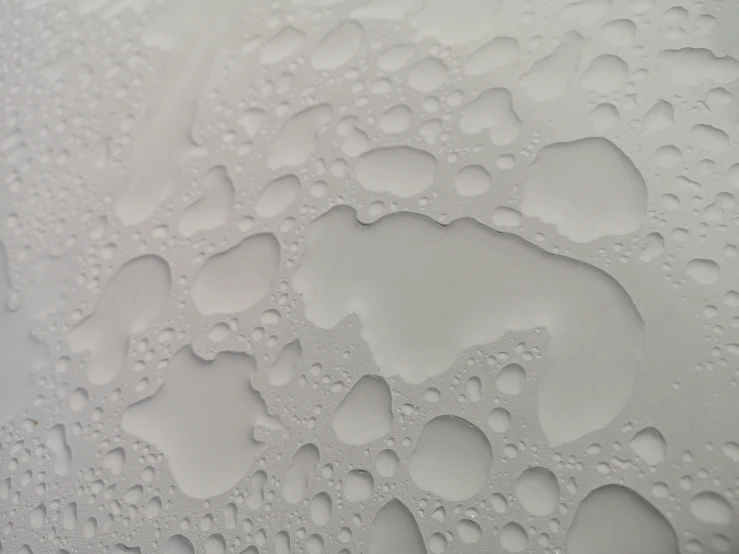 some water drops on a surface in grey colors