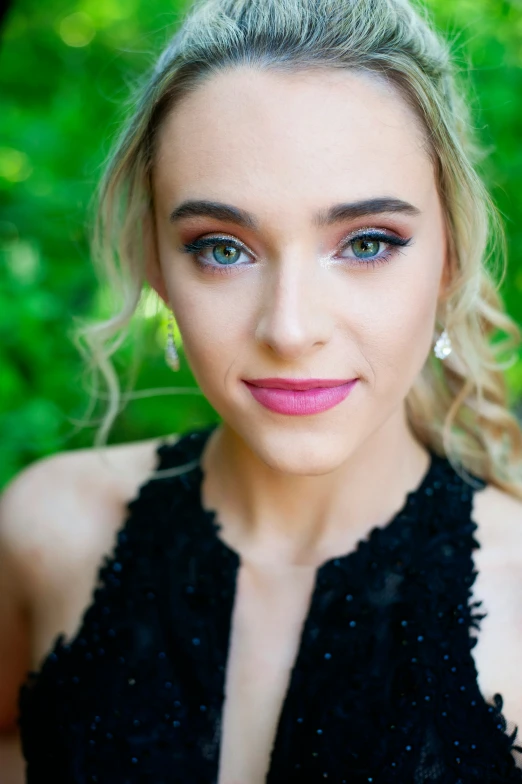 a woman with blonde hair in a black dress