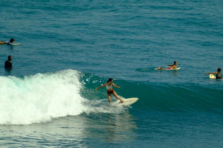 a man riding a wave on top of a surfboard