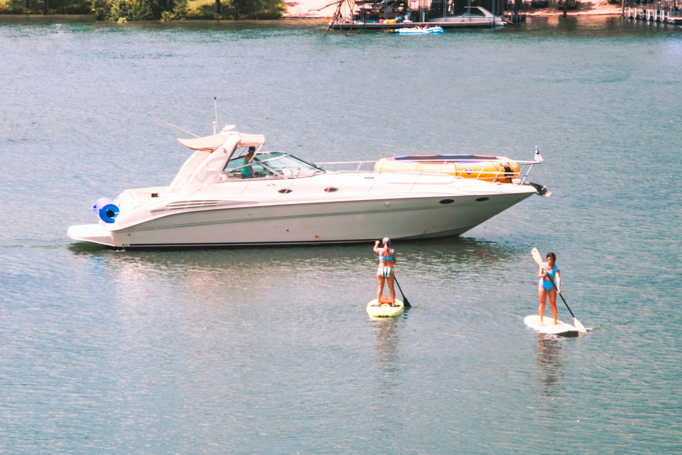 two people paddling their boats in the water