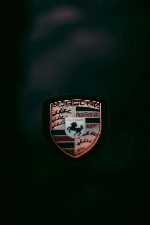 the front end of a red and black car with an emblem