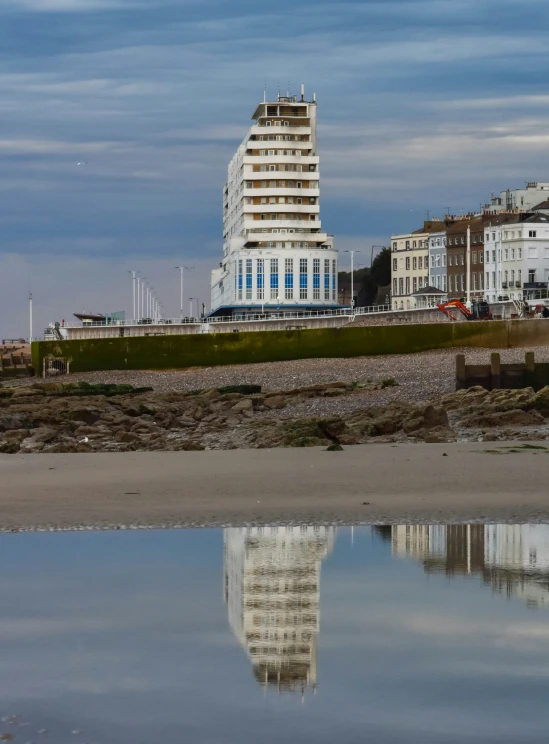 the large tower is reflected in the water