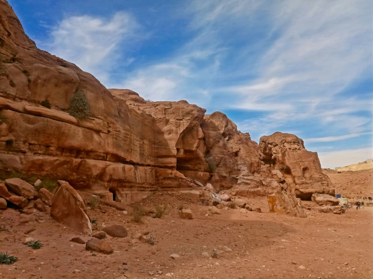 some rocks and a small animal in the middle of a desert