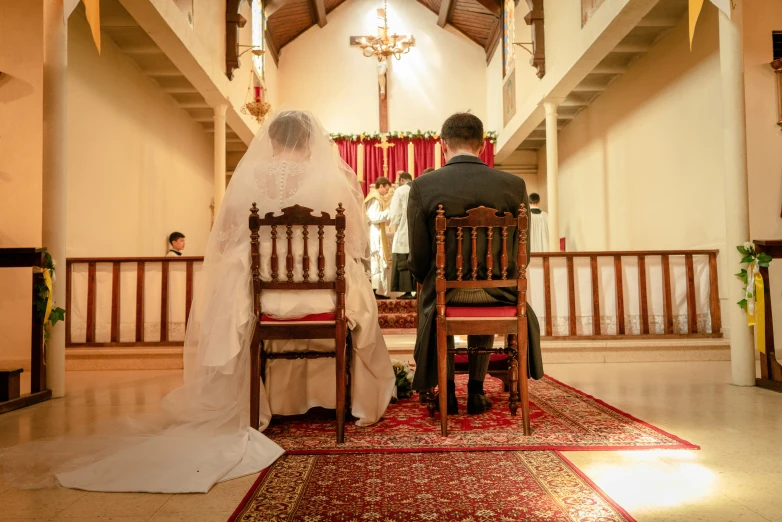 a person kneeling at the alter of a church