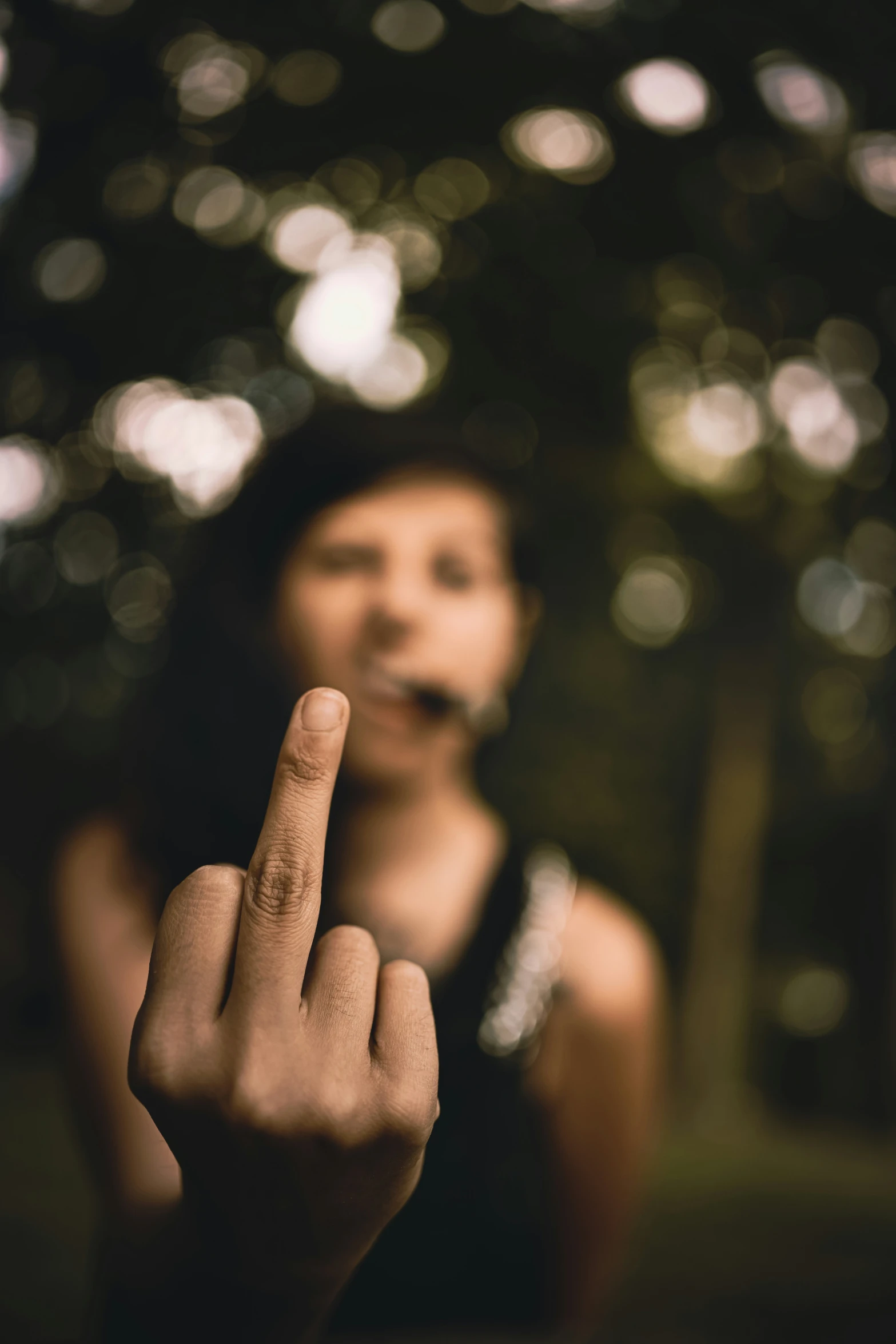 a girl making a peace sign in front of her