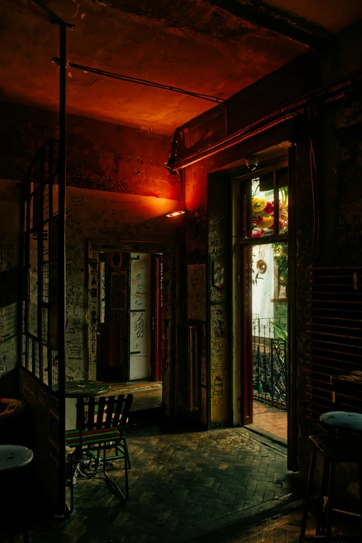 a dark room with benches and tables underneath a light