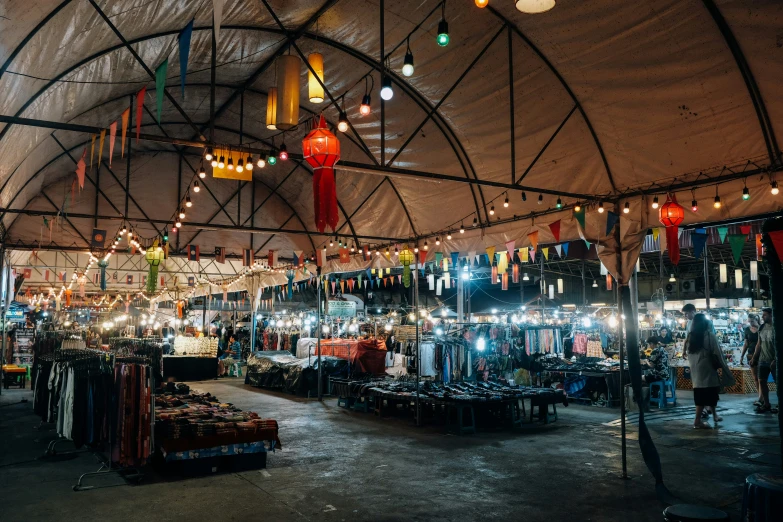 people standing around in a tent covered with lights