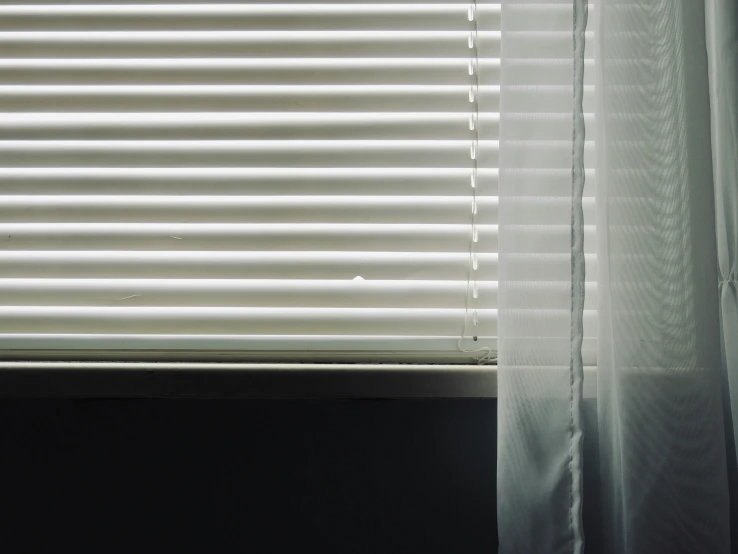 an image of white blinds and curtains that have been ds pulled back