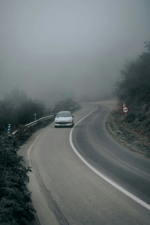 car driving on the road in the foggy weather