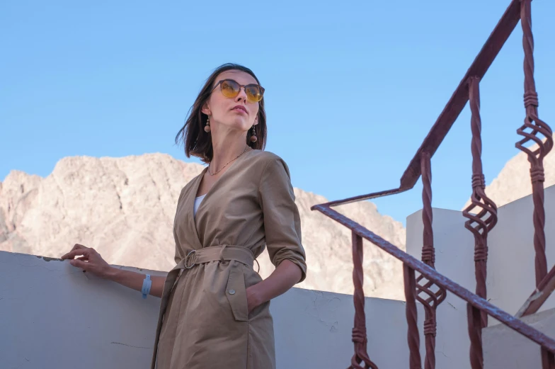 a woman is standing outside in sunglasses