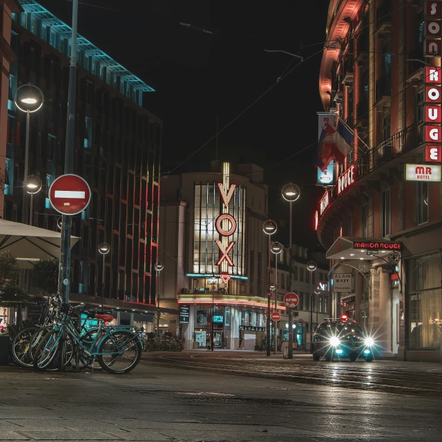 a street at night with a no parking sign and lots of lights