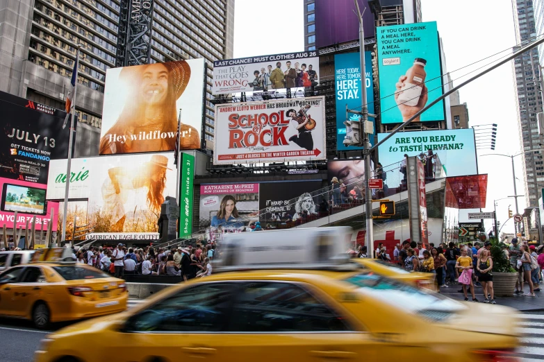 a traffic scene in a big city with many billboards