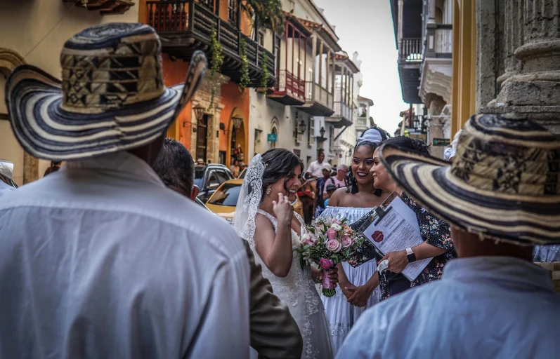 people on the street are wearing sombreros and hats