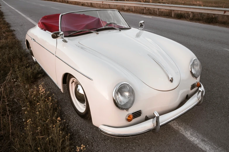 an old car with a red seat has its hood up