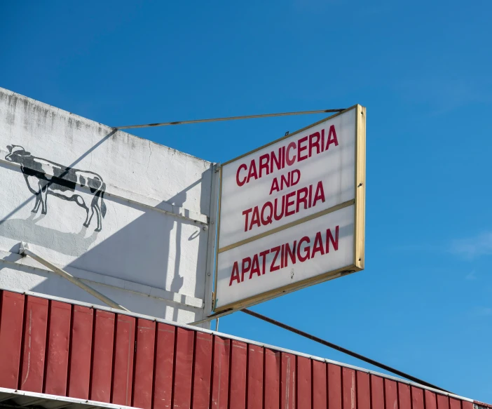 sign on roof saying capriccia and taqueria written on it