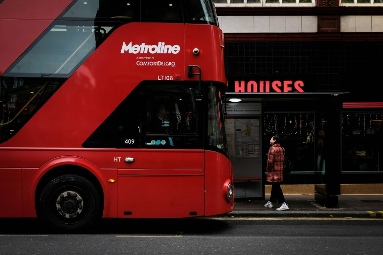 the city bus is red with black lettering on it