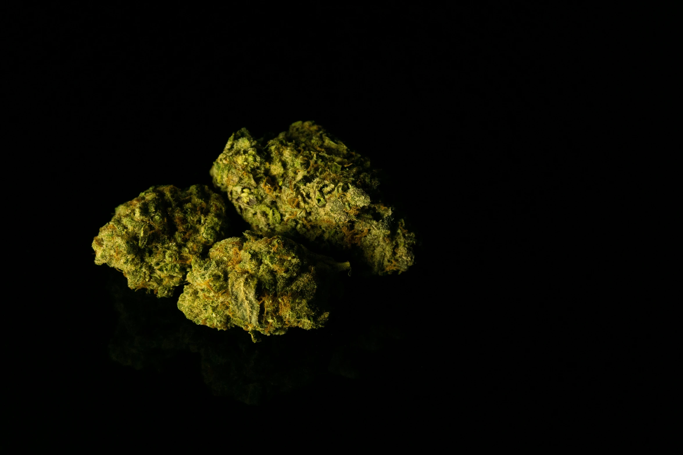 several green buds are arranged in a small pile