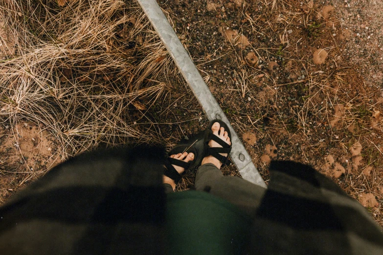 a person's shoes in front of the camera on a walk way