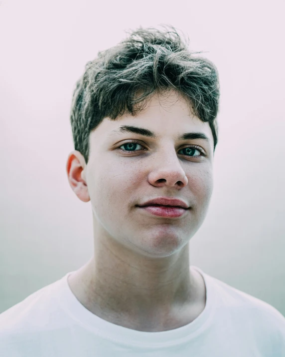 a young man poses for a portrait