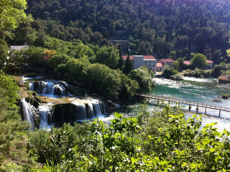 a mountain river with a bridge over the water