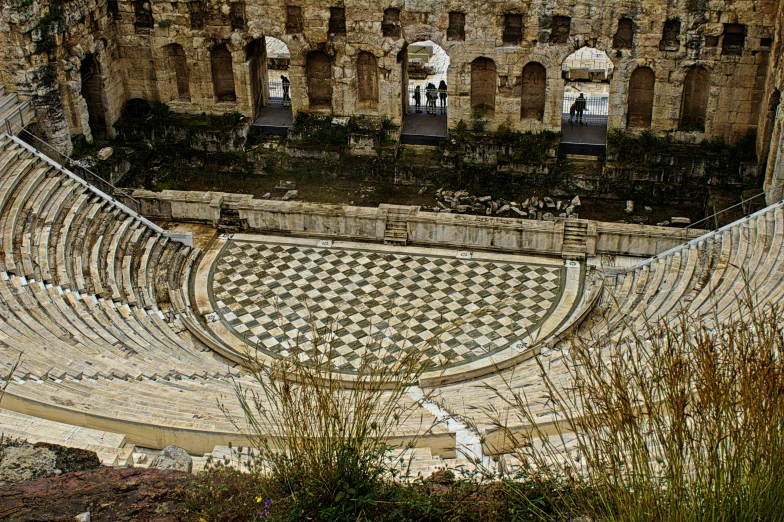 a roman ampeterum has a tiled area with seats in it