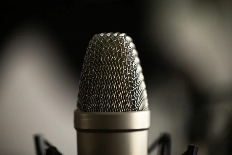 an old fashioned microphone with black corded handles