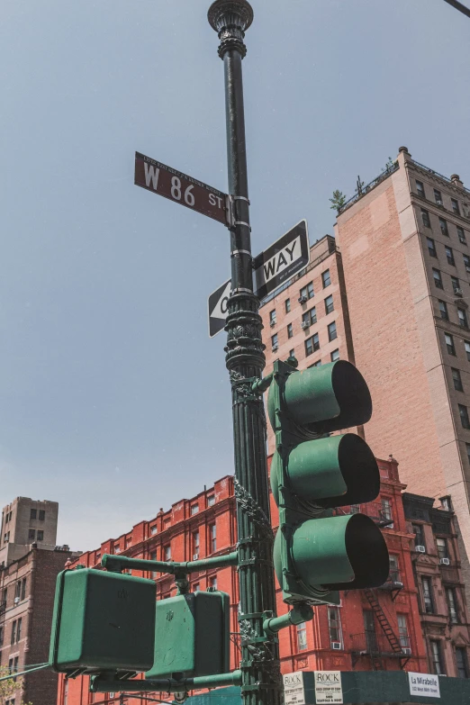 the street light has two street signs on it