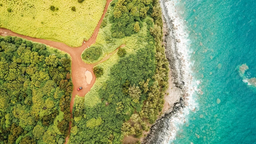 an aerial view of a beach with blue waters