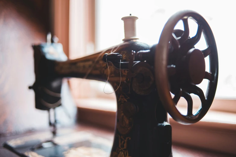 an old sewing machine with a thread