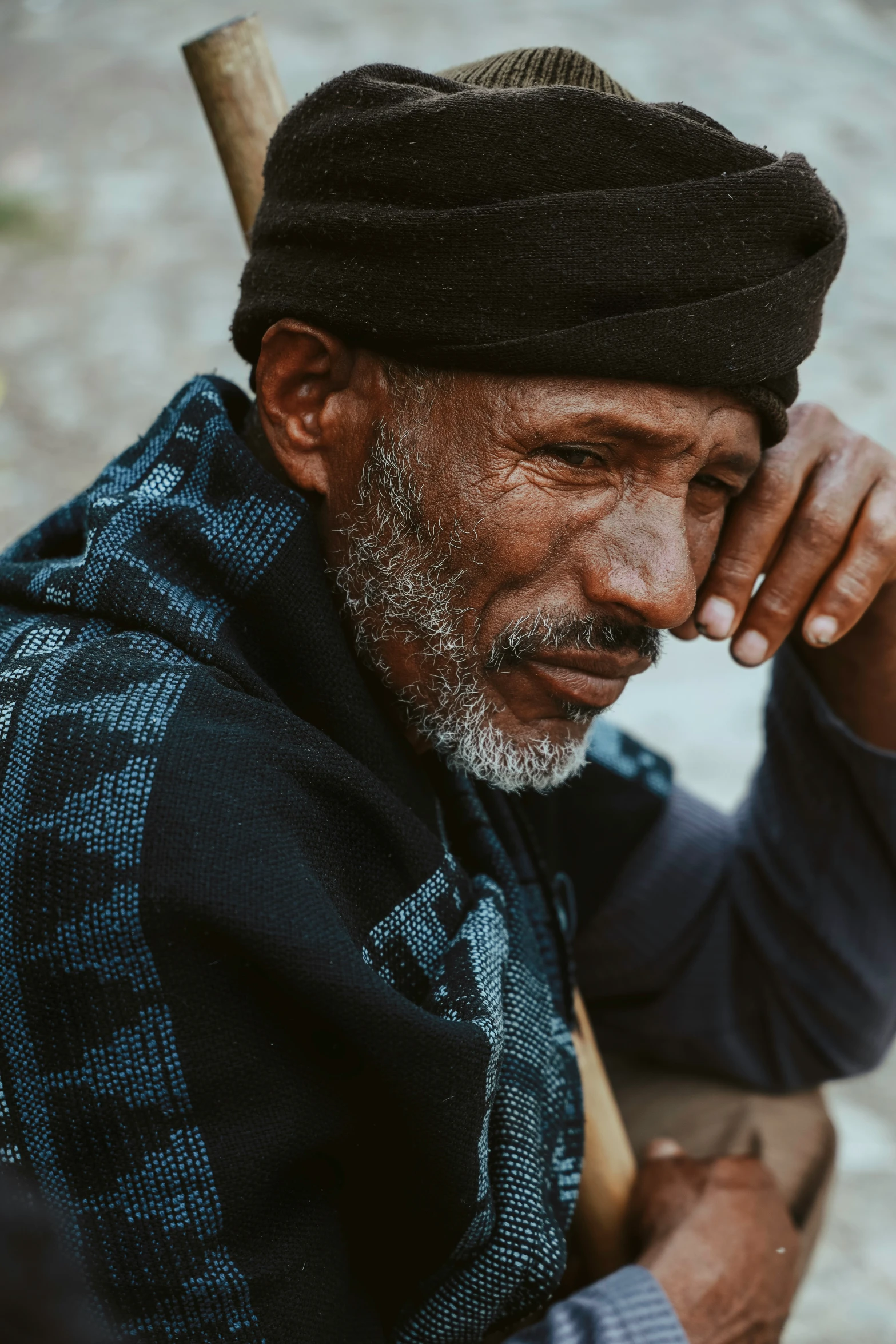 a man holding a baseball bat sitting next to his face