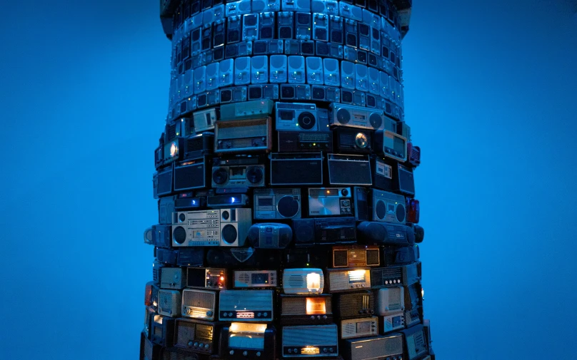 a tall tower with many different electronic equipment on it's side