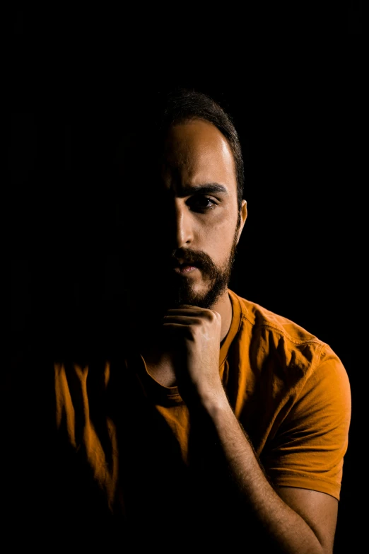 a close up of a person with their hand near his chin