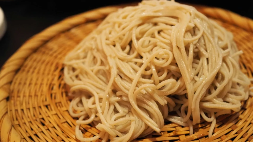 food with noodles on a wicker bowl on the table