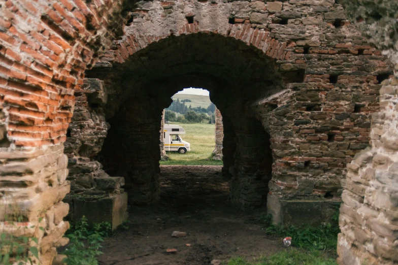 an old, dirty tunnel with dirt and bricks