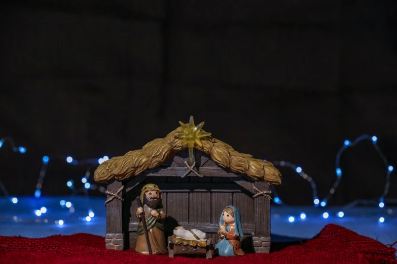a nativity scene of two figurines sitting in the manger crib