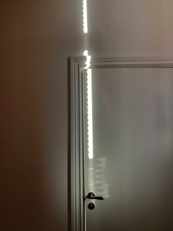 a large mirror with light at the end of it