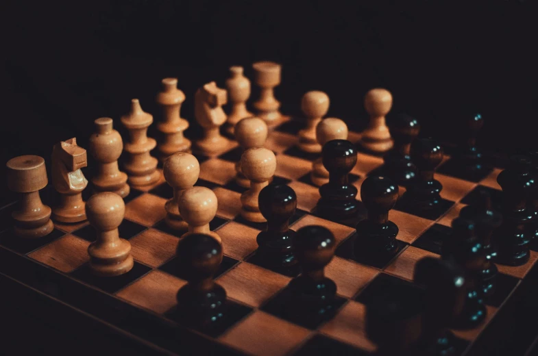 a group of chess pieces sitting on top of a wooden board