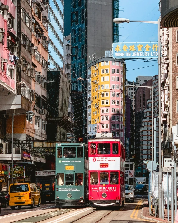 double - decker buses on street in front of buildings