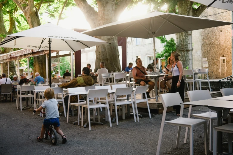 s ride bikes around tables at a restaurant