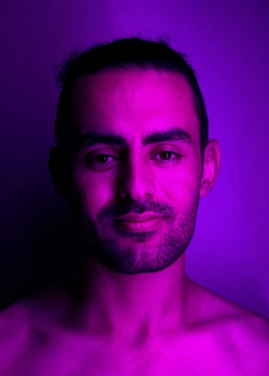 this man is posing for a portrait in a purple room