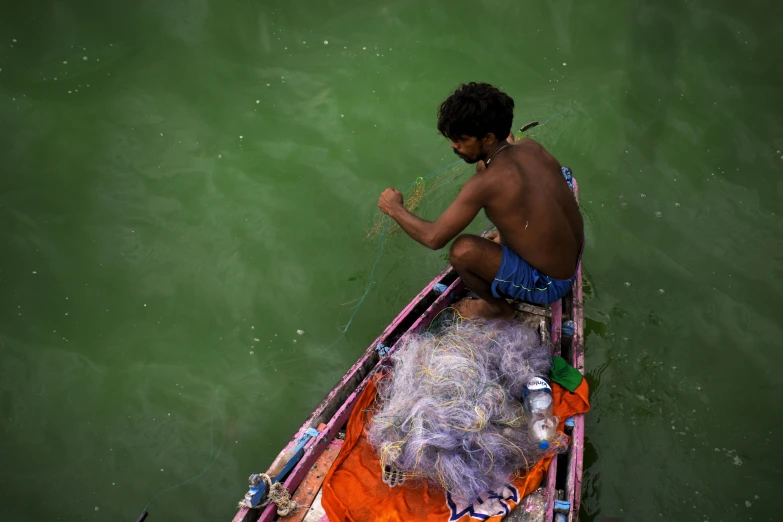 man in a boat with  on sitting back