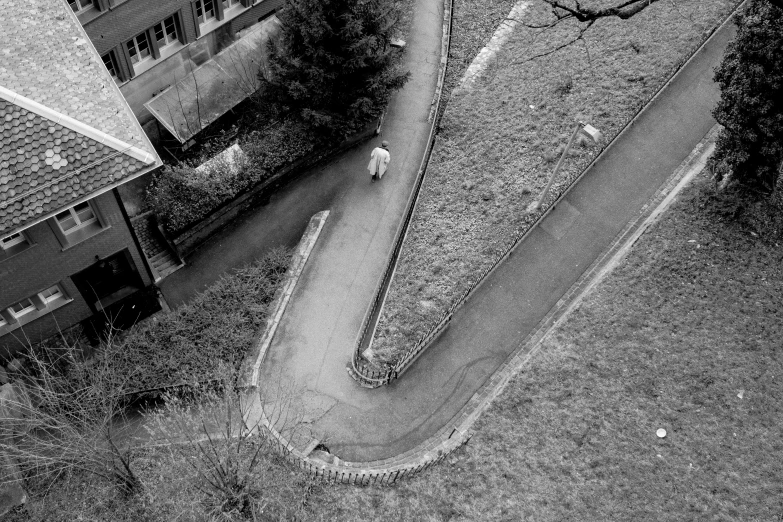 a woman walking on a sidewalk next to houses