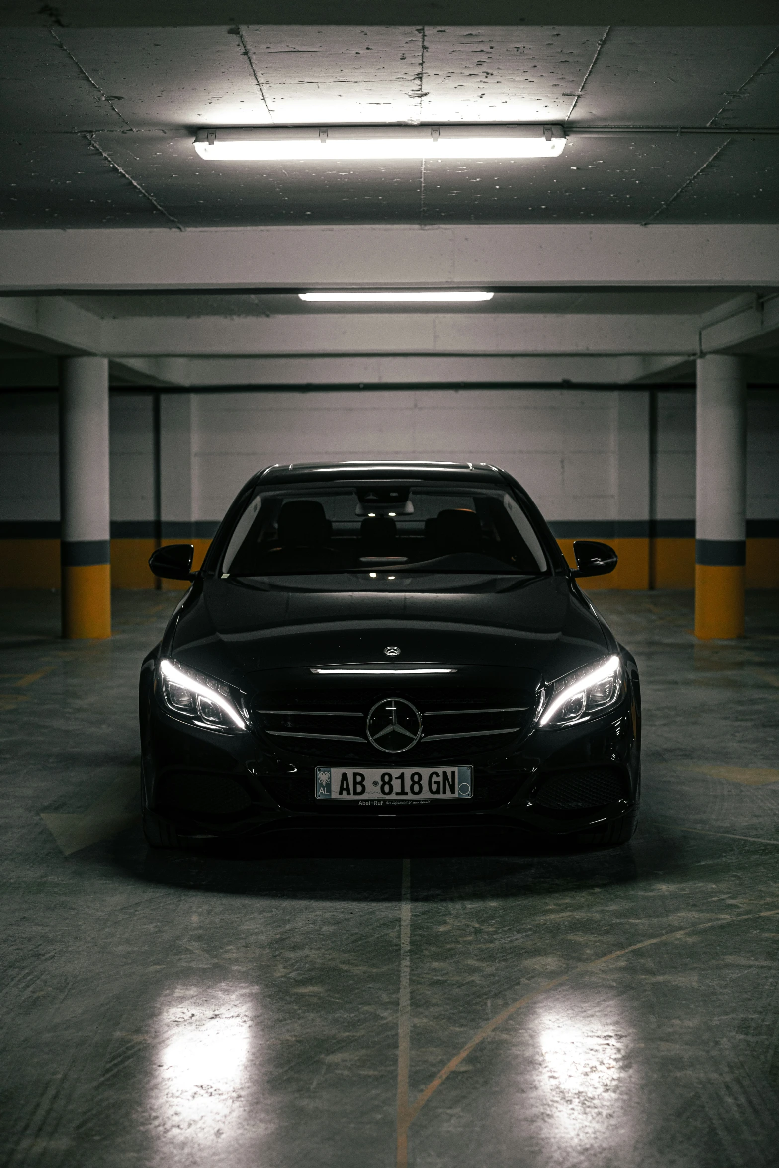 a black car is parked inside of a dark area