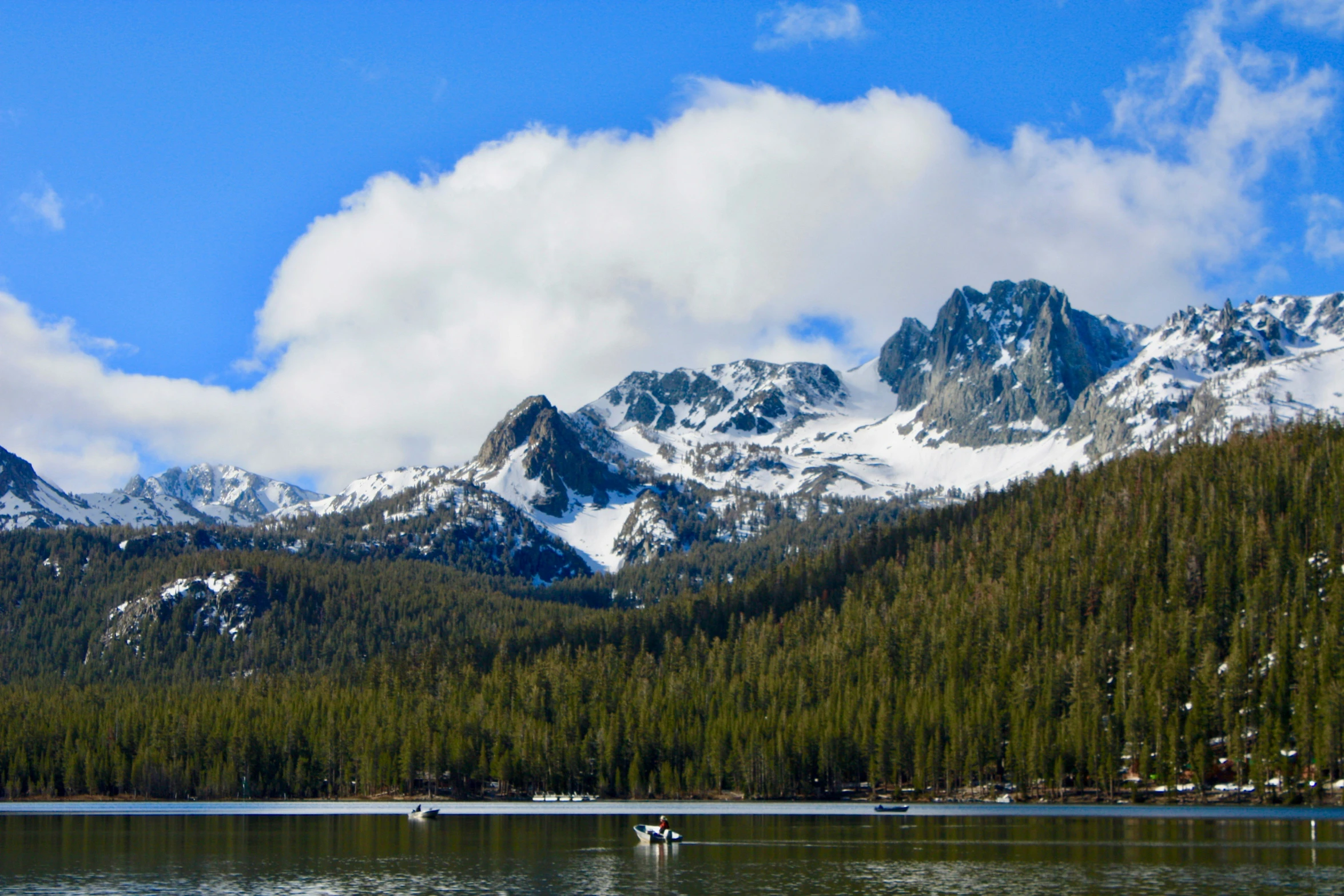 a bunch of people on some water in the mountains