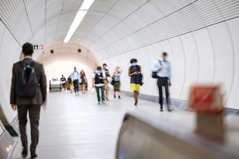 people walking up and down a large subway