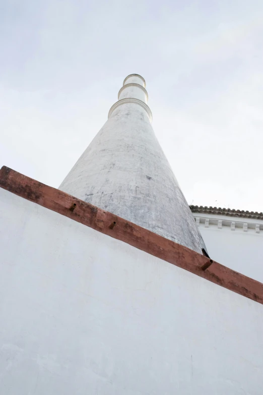 a white building has a red wooden roof