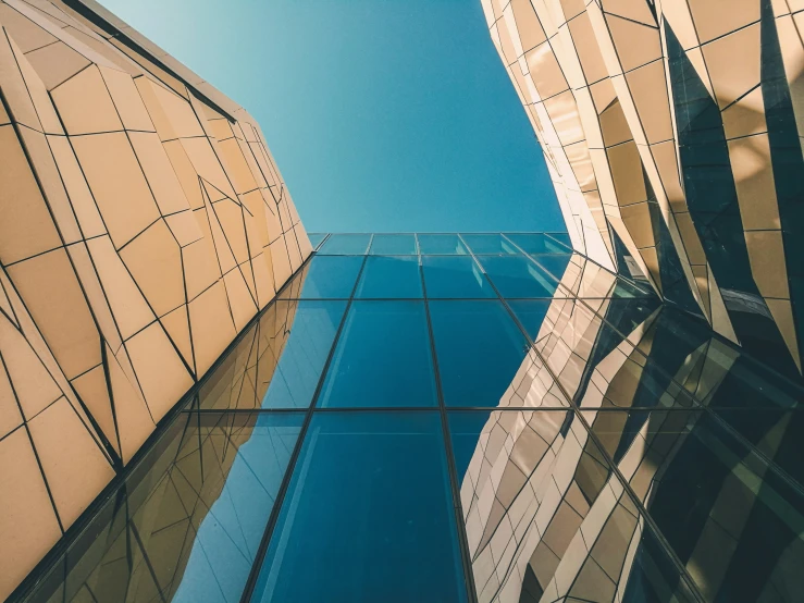 a glass building reflecting another building across the street