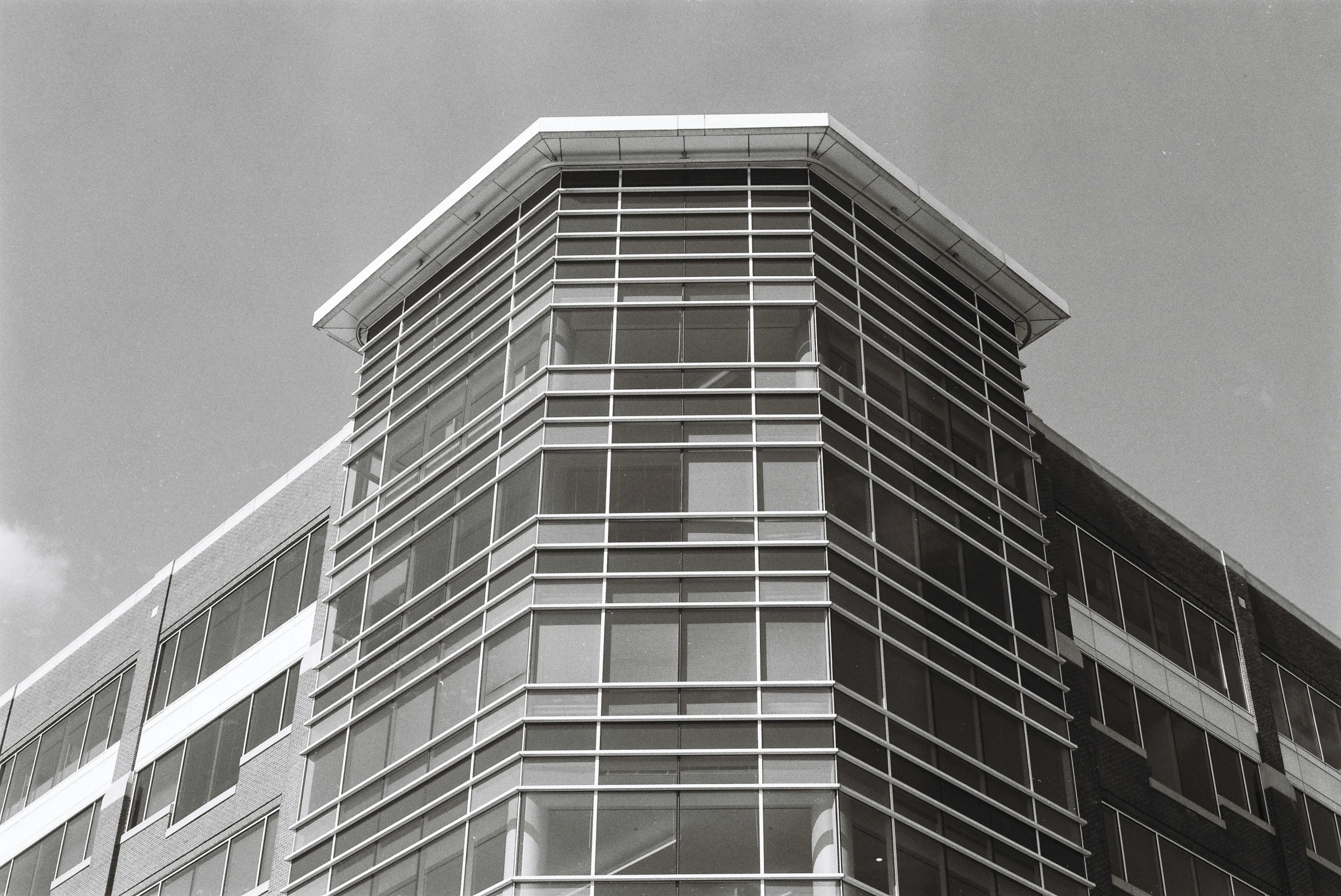 a tall building in black and white near other buildings