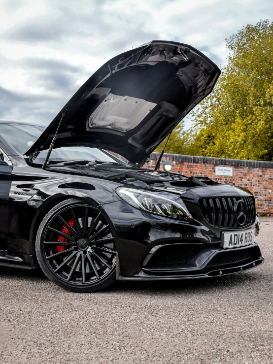 a black car parked with its hood open