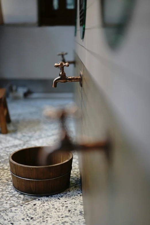 a sink and a bowl on the floor in a bathroom